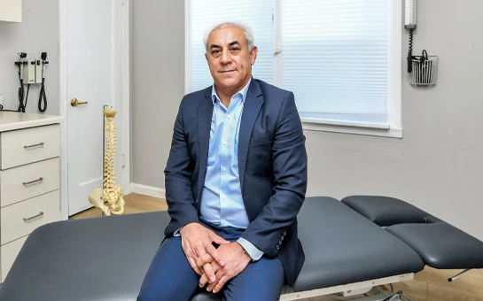 Majid Rezaei Sitting on Adjustment Table